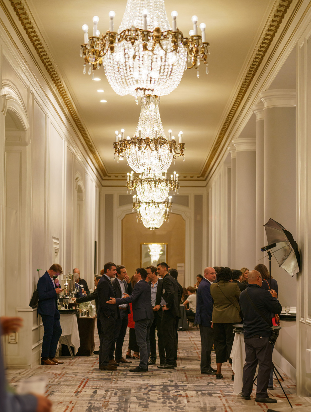 A candid moment of wedding guests casually mingling in the elegant hallways.